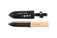 The maru Hori Hori Japanese Gardening Tool features a carbon steel blade, wooden handle, and a leather sheath with Japanese text, ideal for avid gardeners.