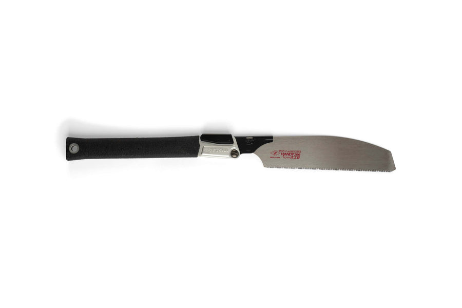 The MARU Z-Saw Folding Japanese Kataba Saw features a black handle and a thin, straight blade with impulse-hardened teeth, shown lying flat on a white background.
