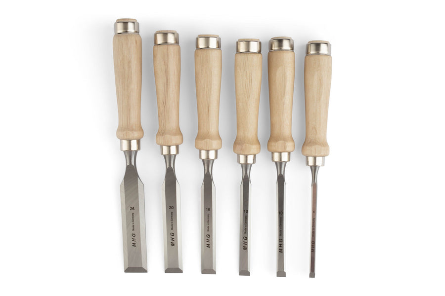 Six MHG Firmer Bench Chisels by MHG, featuring wooden handles and steel blades, essential for fine woodworking, are displayed side by side on a white background.