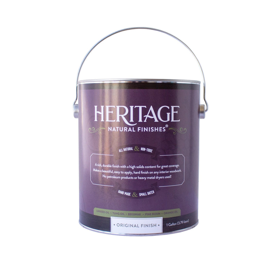 A one-gallon can of HNF Heritage Natural Finishes Oil Select Interior & Exterior displays a purple and white label with detailed product information, emphasizing its water resistance. Additionally, it includes a metal handle at the top.