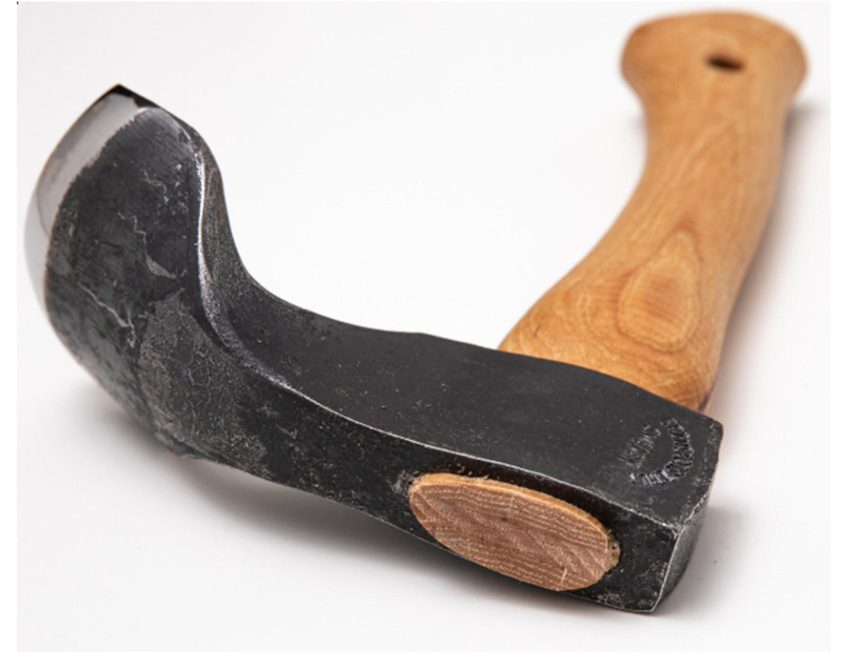 A Gränsfors Bruk Small Gutter Adze Radius 40 Second Grade by Gransfors Bruk, featuring a wooden handle and a detached black metal head reminiscent of traditional log building or timber hollowing tools, is displayed on a white background.