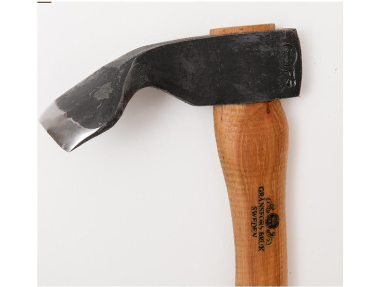 The Gransfors Bruk Small Gutter Adze Radius 40 Second Grade features a curved blade and a wooden handle with a stamped black metal head. Designed for hollowing timber and ideal for log building, this tool from Gränsfors Bruk is photographed against a plain white background.