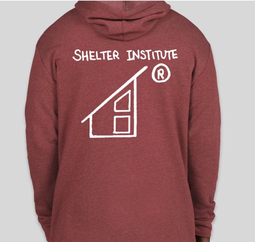 The back of the maroon 50th Anniversary Sweatshirt by Custom Ink features a white logo and "Shelter Institute" text with a house design, celebrating 50 years of building knowledge. Pairs perfectly with our cozy Tri-Blend sweatshirts for added comfort.