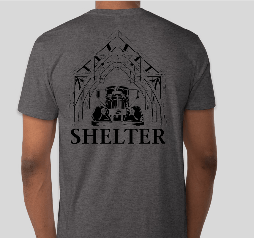 The Shelter Mack Truck T-Shirt by Custom Ink features a line drawing of a house with a 1951 Model A Mack Truck and two dogs on the back, plus SHELTER in bold black letters—a tribute to Woolwich, Maine craftsmanship.