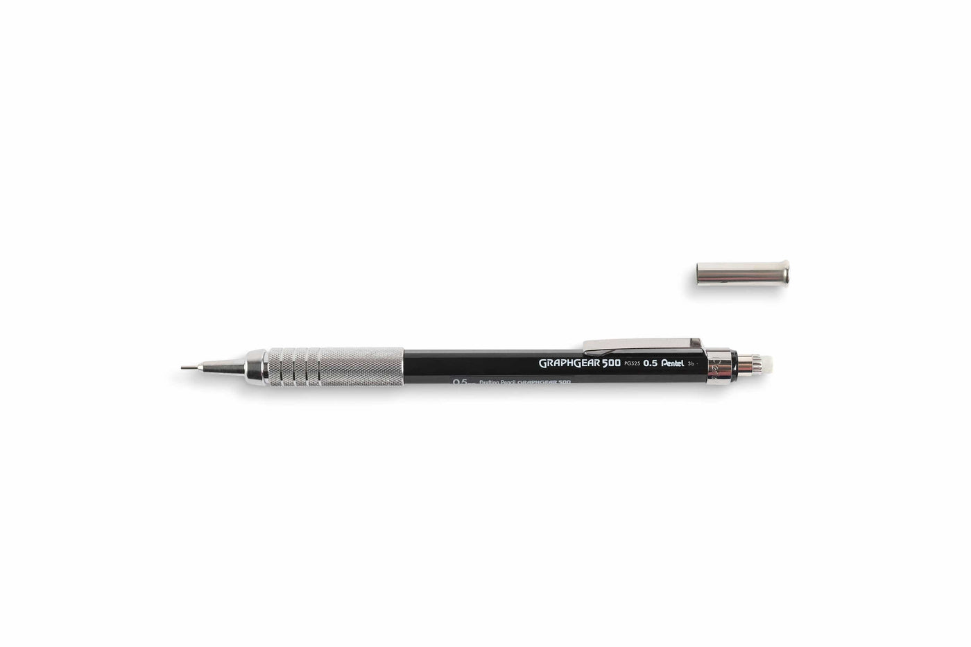 The Dick Blick GraphGear 500 Mechanical Pencil, ideal for drafting, lies horizontally with a glistening metal grip. Its cap is above it, revealing a fine lead for precision.