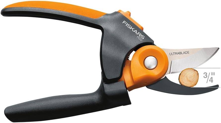 A FIS Fiskars Power Gear2 pruner with black and orange handles uses PowerGear technology and a bypass-style steel blade to cut small wood branches up to 3/4 inch, reducing hand fatigue.