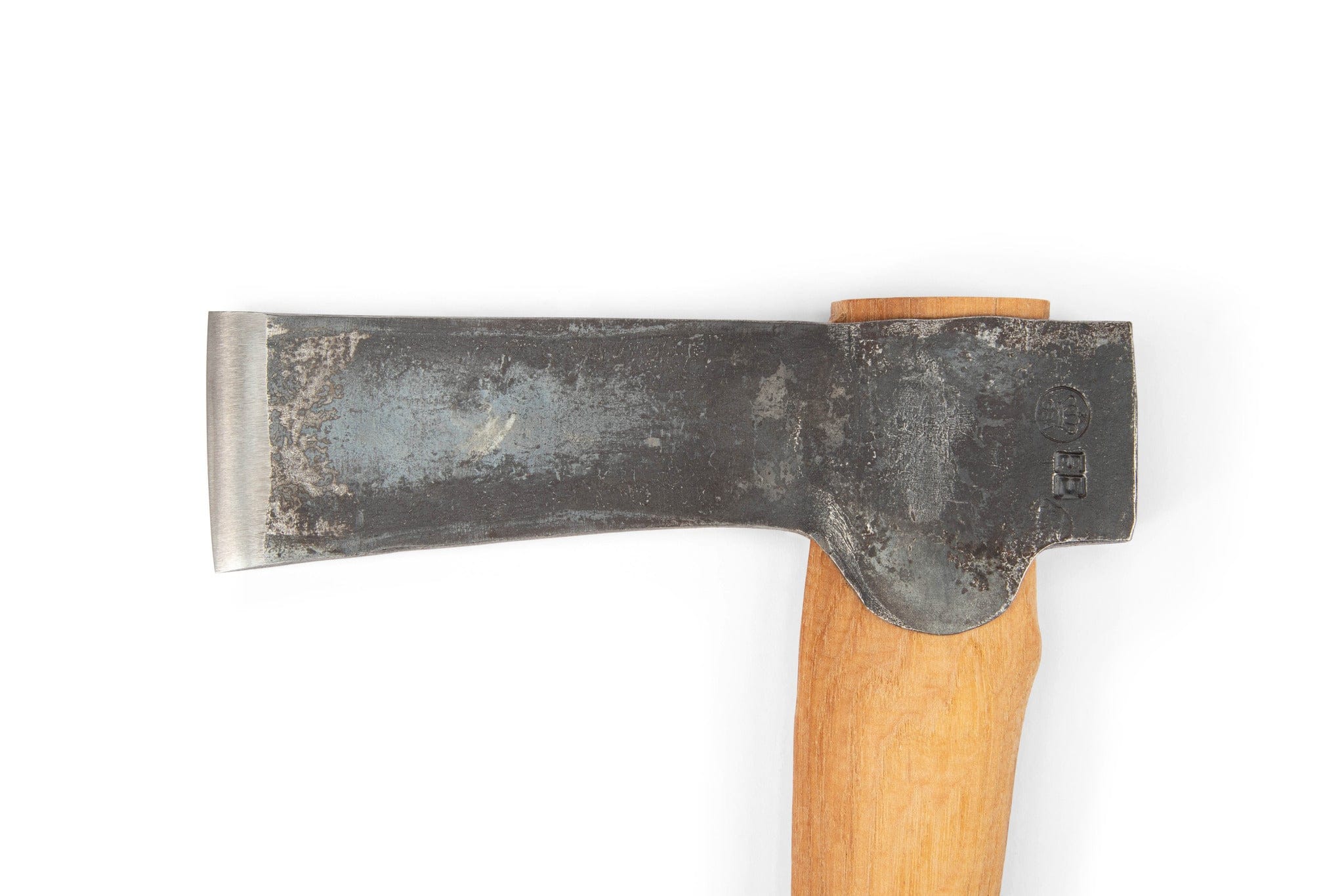 A close-up of the GRF Gransfors Bruk Mortise Axe, showing its worn metal blade and smooth light wood handle for precise timber joinery, photographed on a plain white background.