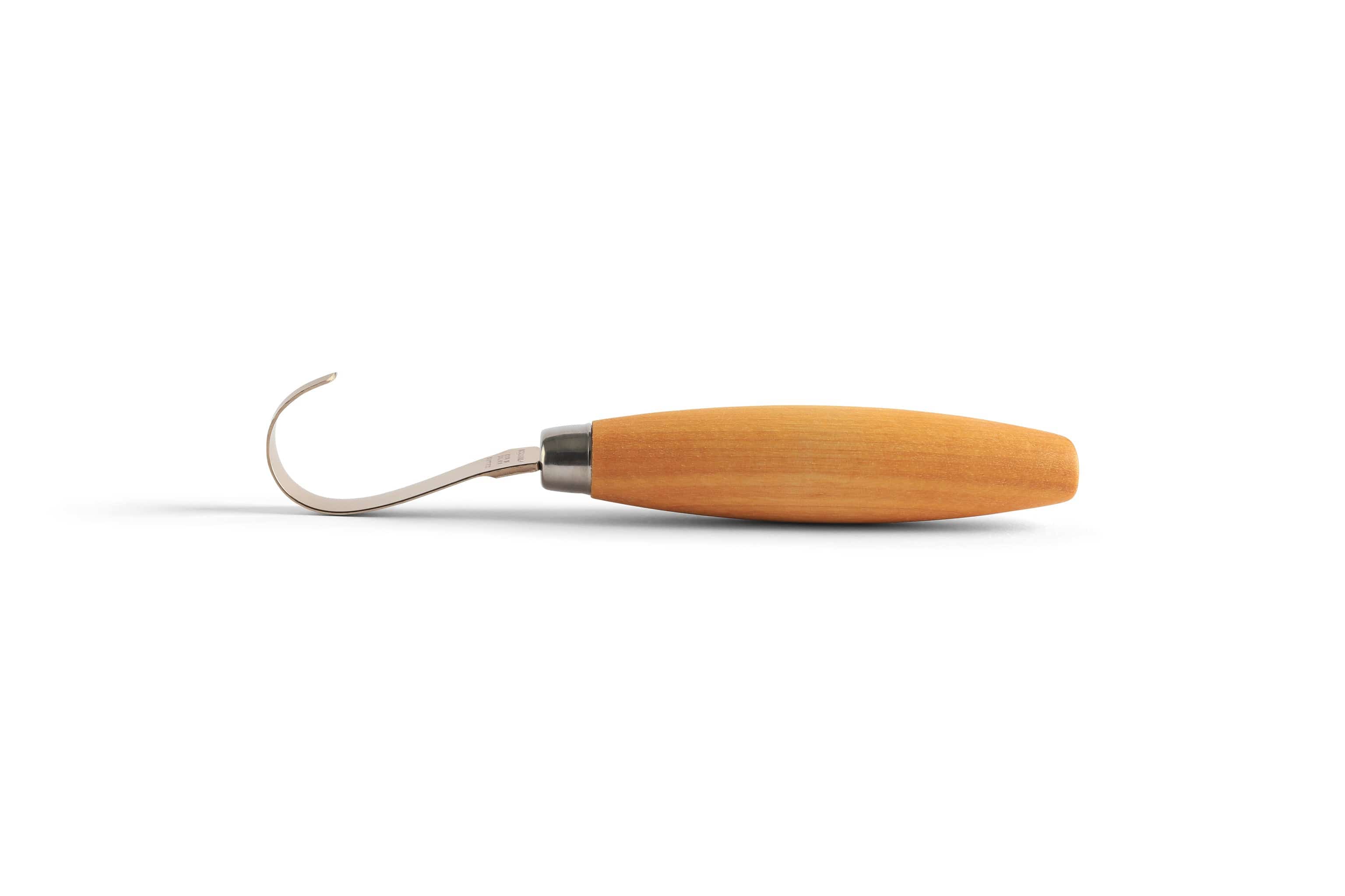 An Industrial Revolution Mora Hook Knife, featuring a wooden handle and curved metal blade, is shown against a plain background—ideal for spoon or bowl carving enthusiasts.