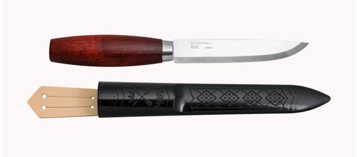 The Classic Mora Knife from Industrial Revolution features a durable high-carbon steel fixed blade, a beautifully crafted birch wood handle, and comes with a sleek black sheath.