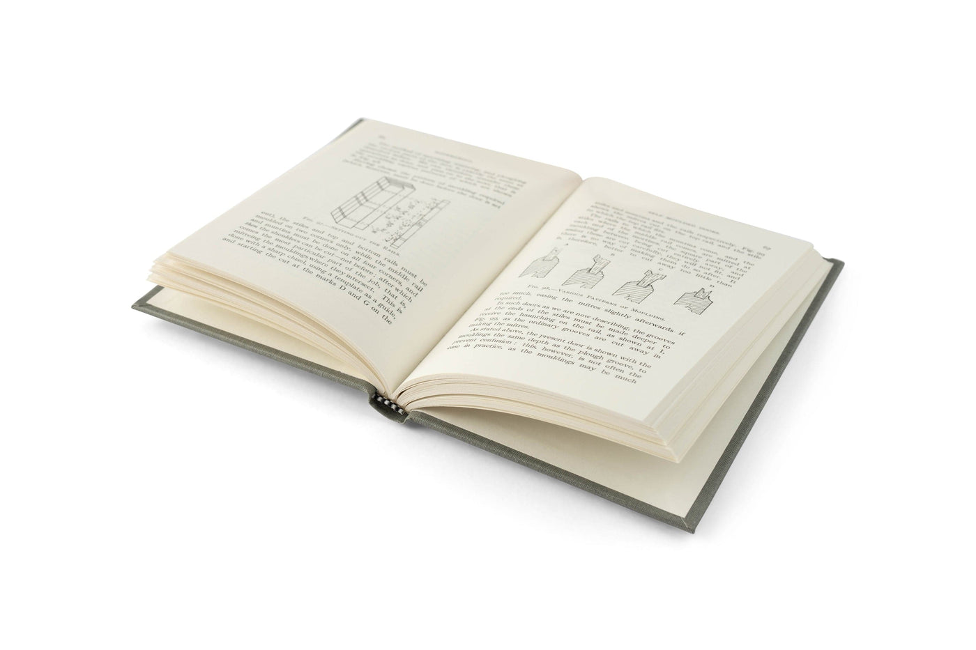 An open book titled Doormaking and Window-Making by LAP lies on a white surface, showing diagrams and text on both pages that illustrate traditional joinery and window-making techniques.