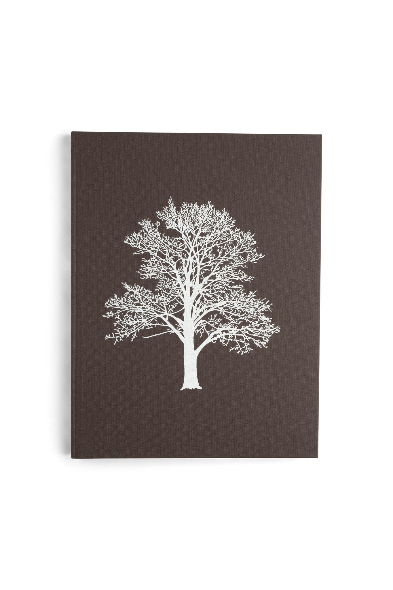With the Grain: A Craftsmans Guide to Understanding Wood by LAP is a dark brown hardcover notebook featuring a white silhouette of a leafless tree on the front, inspired by North American wood and furniture-making wisdom.