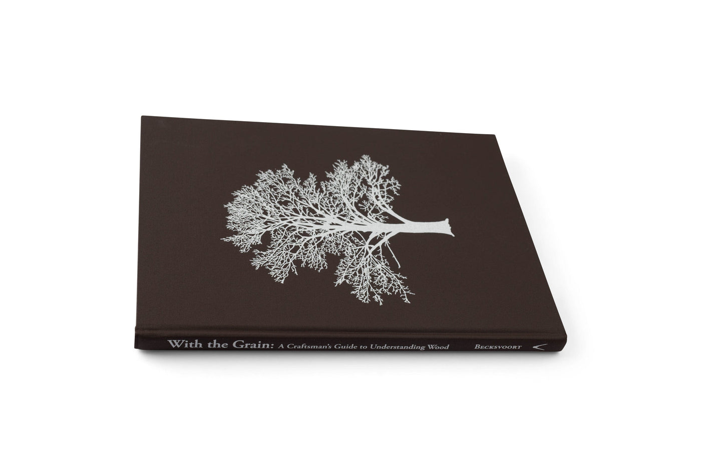 LAP’s “With the Grain: A Craftsmans Guide to Understanding Wood” is a hardcover book with a dark cover and white tree illustration, offering furniture-making wisdom for working with North American wood species.