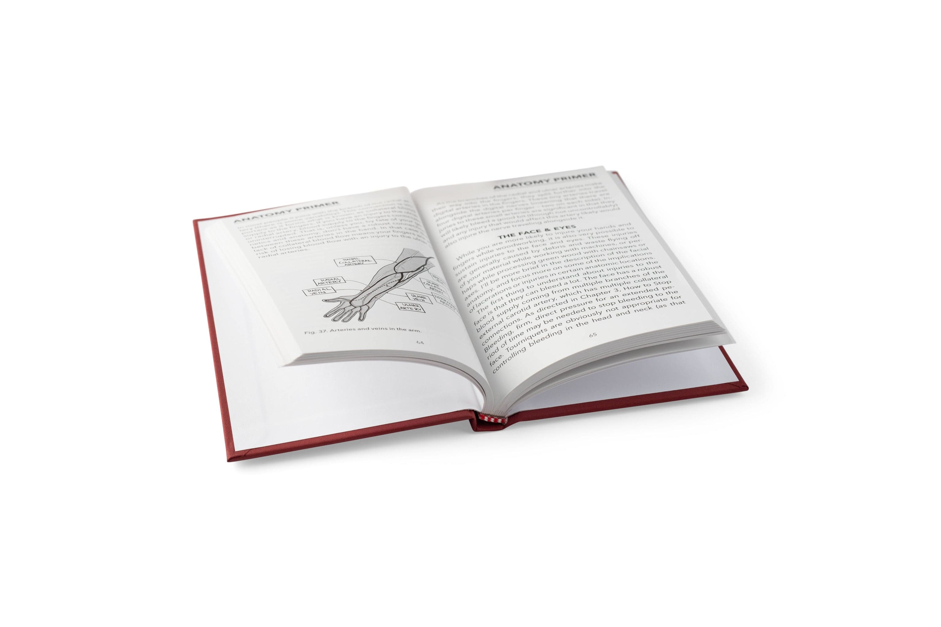 The LAP book Workshop Wound Care is open on a white surface, showing text and an arm diagram—ideal for learning first aid and care tips for woodworking injuries.