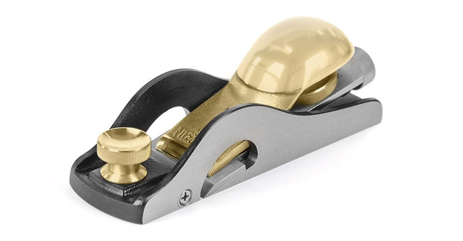 The Lie-Nielsen 60-1/2 Rabbet Block Plane with Nicker features brass components, an adjustable knob, and a smooth handle, offering precision craftsmanship—ideal for woodworking therapy.
