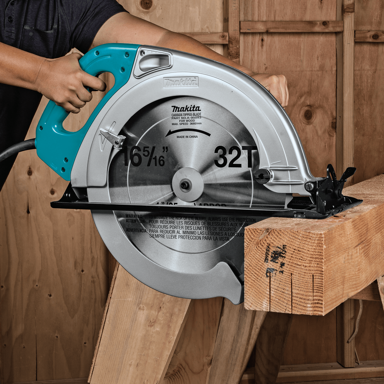 In a workshop, a person expertly uses the Makita Circular Saw to cut through a thick wooden beam, leveraging its powerful 15 AMP motor and large cutting capacity.