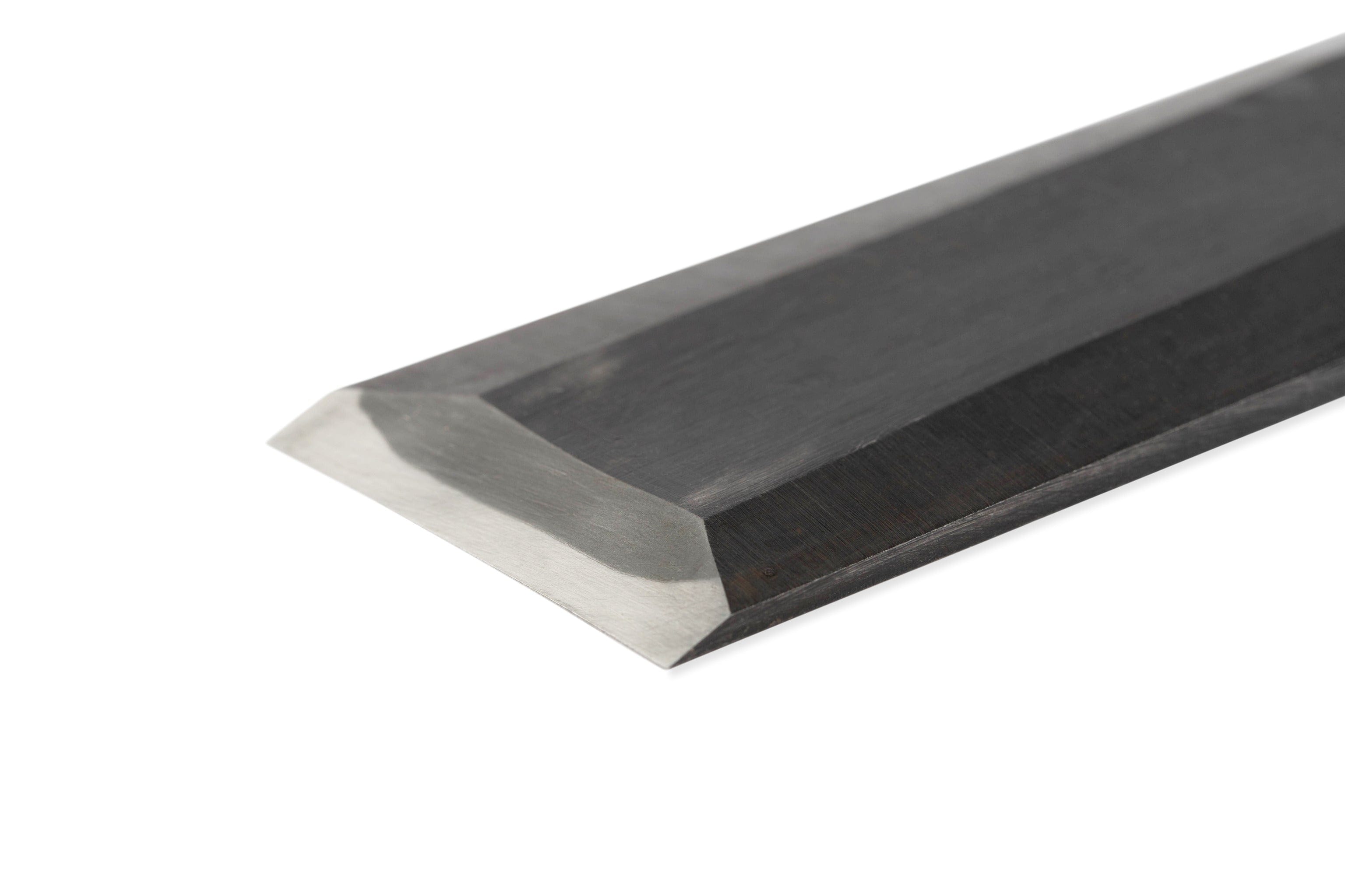 Close-up of a polished beveled tip on the Maru Japanese Timber Framing Slick, highlighting its sharpness and clean lines that reflect expert Japanese craftsmanship.