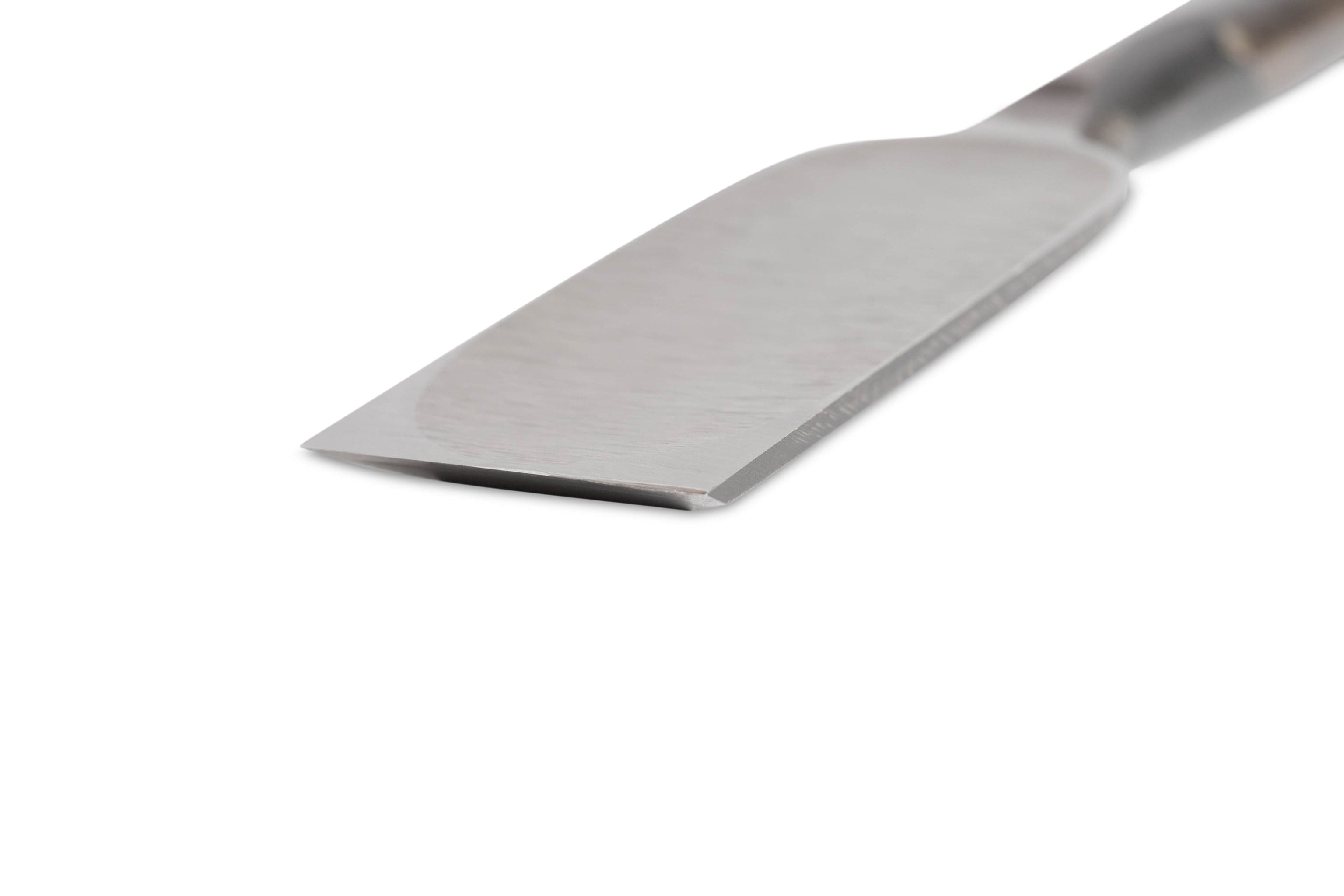 A close-up of the MARU Japanese Timber Framing Chisel shows a flat, shiny white steel blade and a smooth, angled handle against a plain white background.