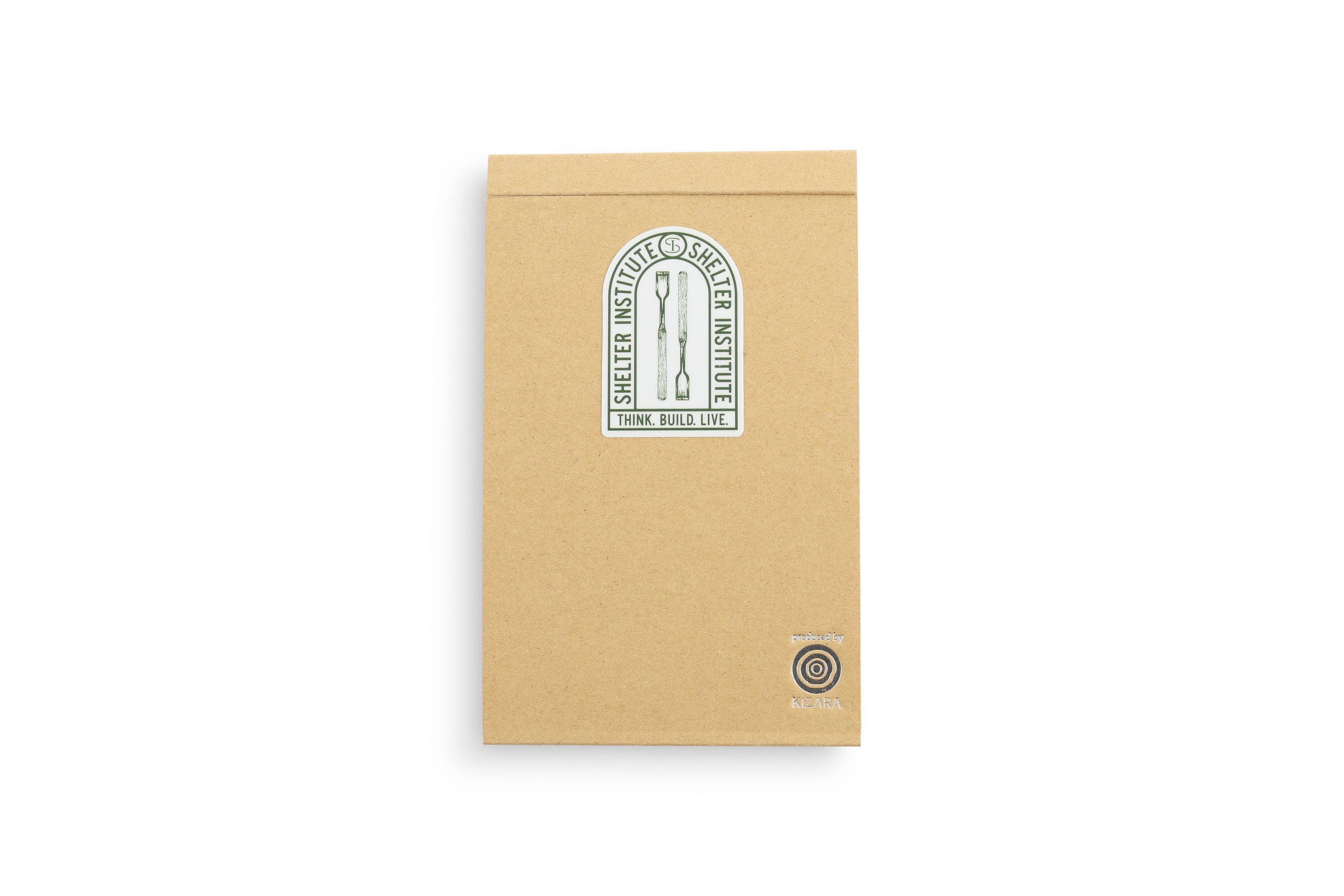 Brown notepad featuring the Shelter Institute logo and the tagline Think Build Live, inspired by MARUs Kyougi Wooden Notepad, showcases Japanese craftsmanship and sustainable forestry. It includes a circular emblem with an arrow icon in the bottom right corner.