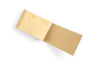 The Kyougi Wooden Notepad by MARU, featuring open blank pages on a white background, exemplifies eco-conscious craftsmanship.