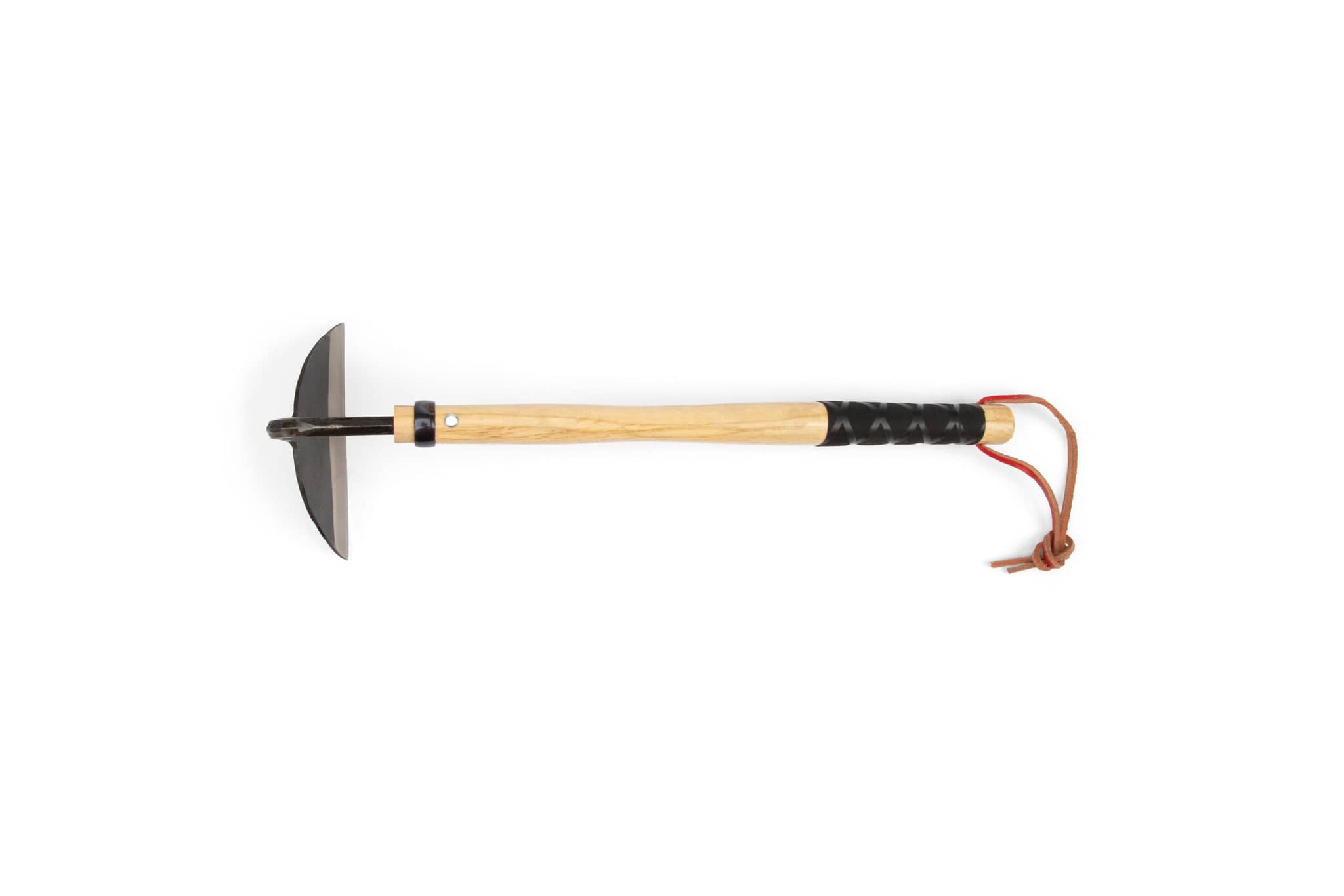 The MARU Japanese Grass Cutter features a wooden handle, a black metal head with a sharpened blade, and a leather wrist strap, displayed against a white background.