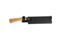 The MARU Japanese Gardening Machete, with a wooden handle showcasing traditional craftsmanship, is partially visible in its black leather cover against a plain white background.