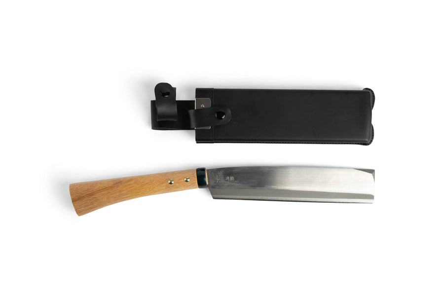 The MARU Japanese Gardening Machete, a versatile kitchen knife with a wooden handle, pairs elegantly with its black leather sheath on a pristine white background, showcasing precision and craftsmanship.
