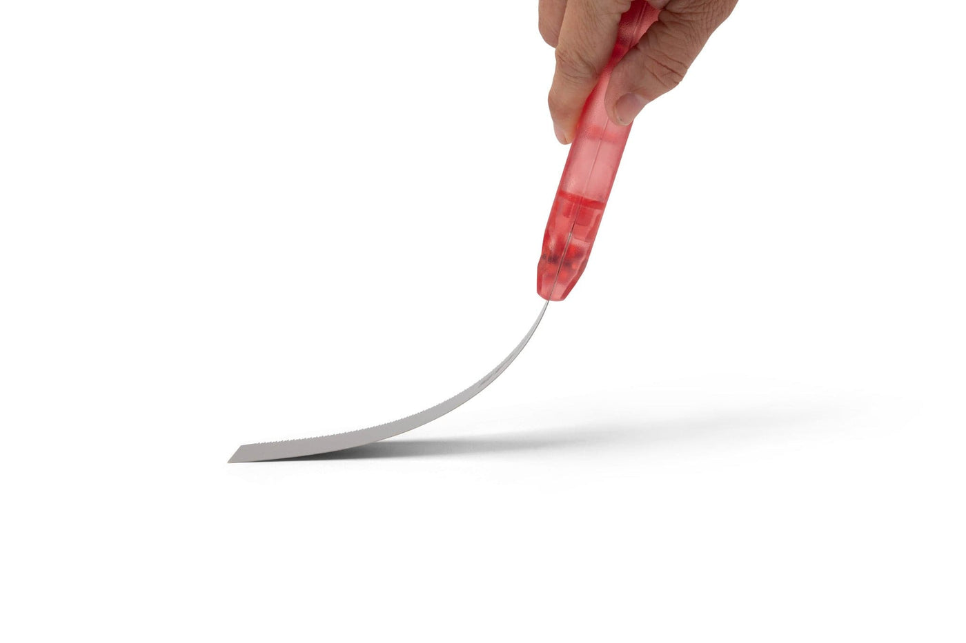 A hand holds the MARU Japanese Flush Cut Saw, featuring a red handle and an ultra-thin, flexible curved blade, set against a white background.