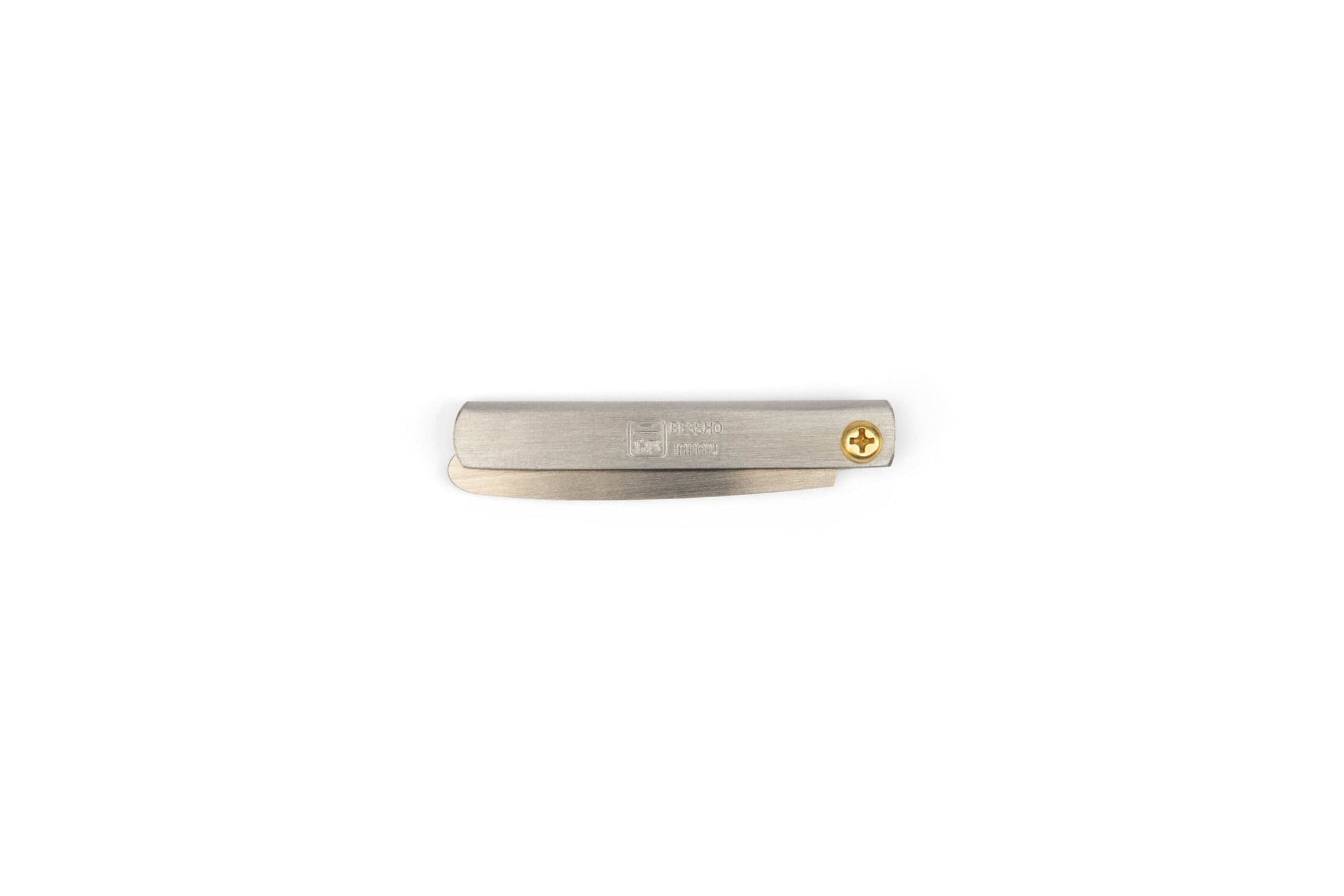 A closed MARU Miniature Japanese Folding Saw with a brass screw pivot, perfect for ultralight backpacking, lies horizontally on a plain white background.
