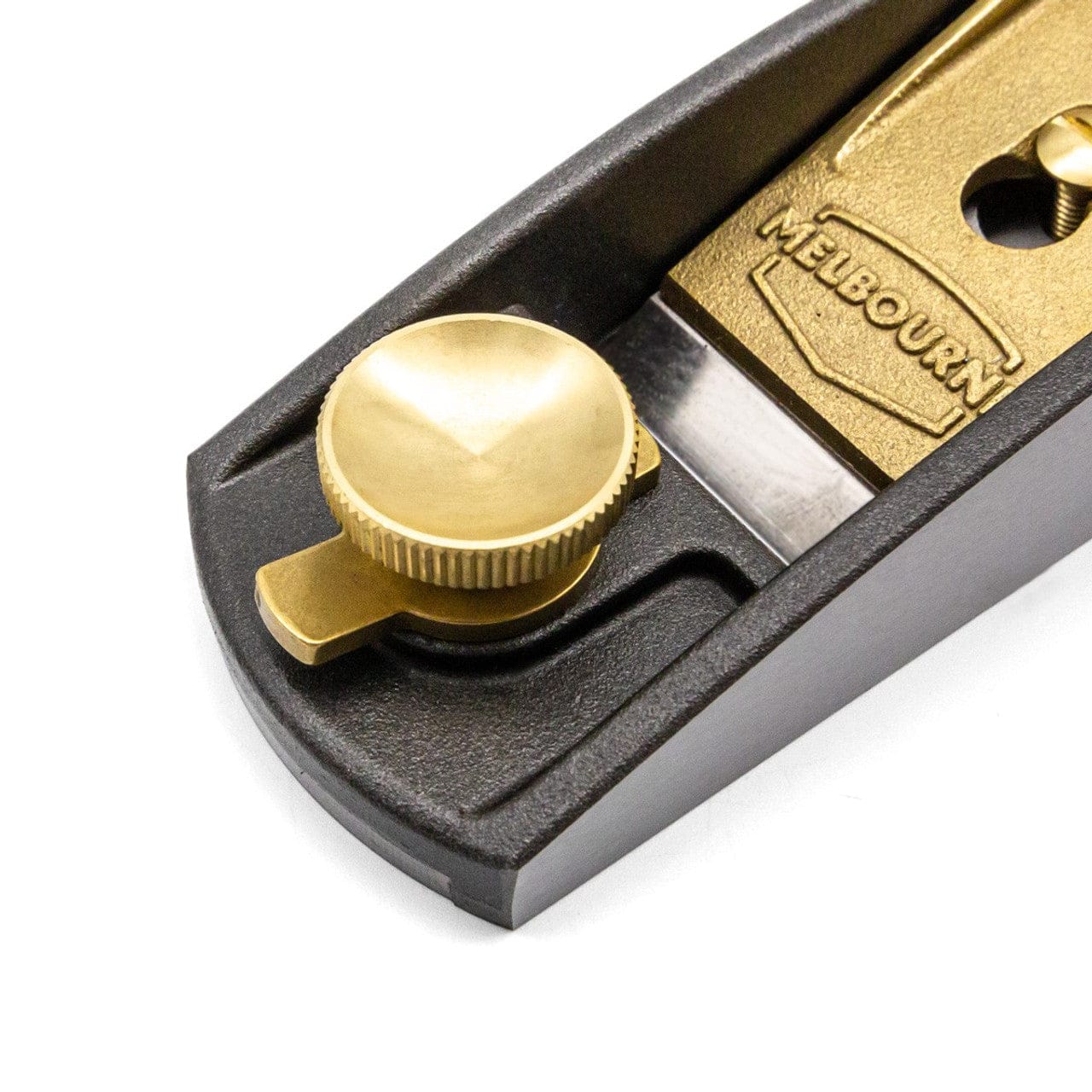 Close-up of the Melbourne Tool Company Low Angle Block Plane, featuring a brass adjustment knob, gold-colored MELBOURNE label, and M2 High Speed Steel blade. The dark metal body makes it ideal for detailed woodworking.