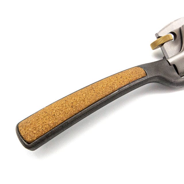 Close-up of a black handle with brown cork grip, attached to the Melbourne Tool Company Sole Spokeshave—a precise woodworking tool featuring a brass adjustment knob.