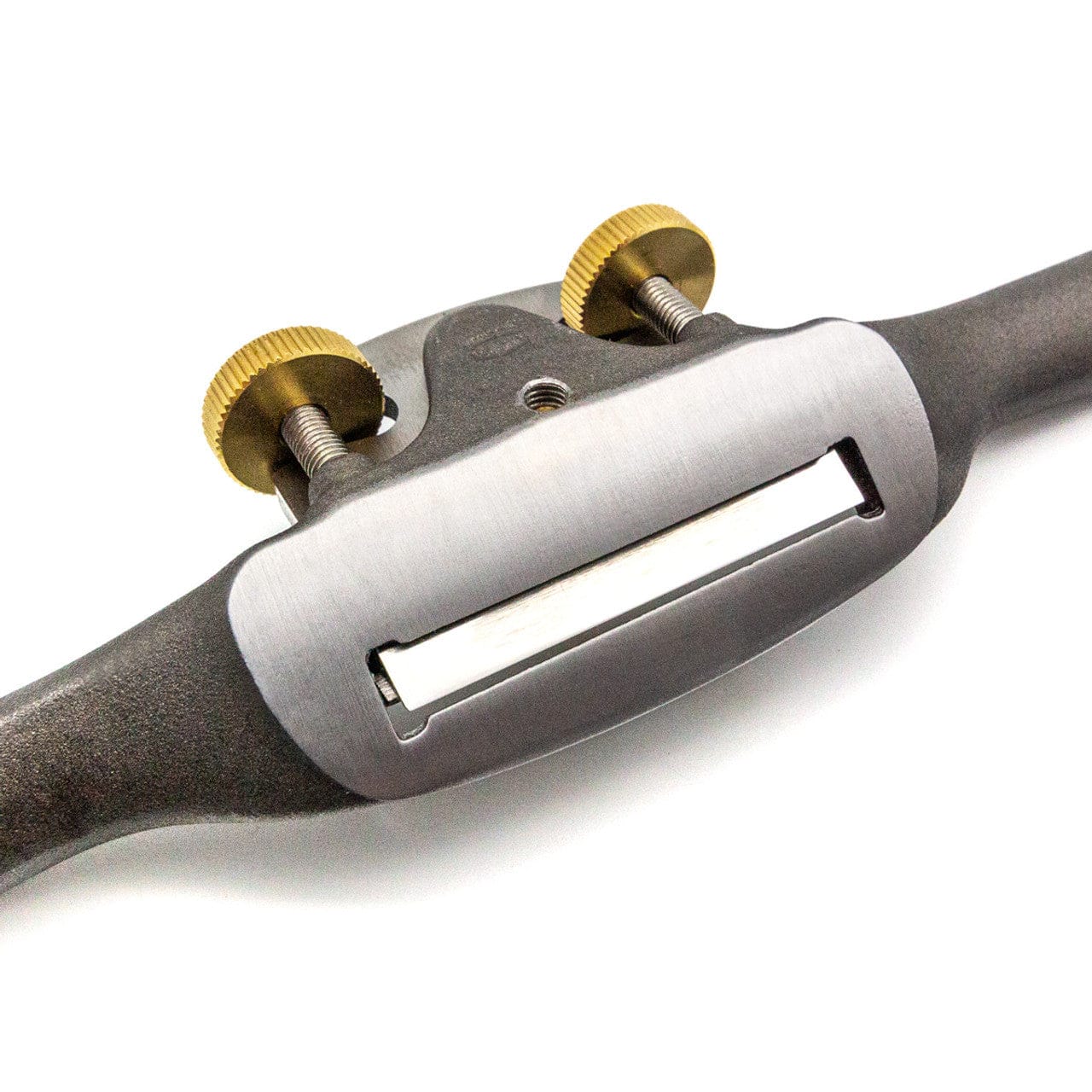 A close-up of the Melbourne Tool Company Sole Spokeshave, a precise convex wood shaping tool with two brass adjustment knobs and a sharp, exposed blade, from Melbourne Tool Company.