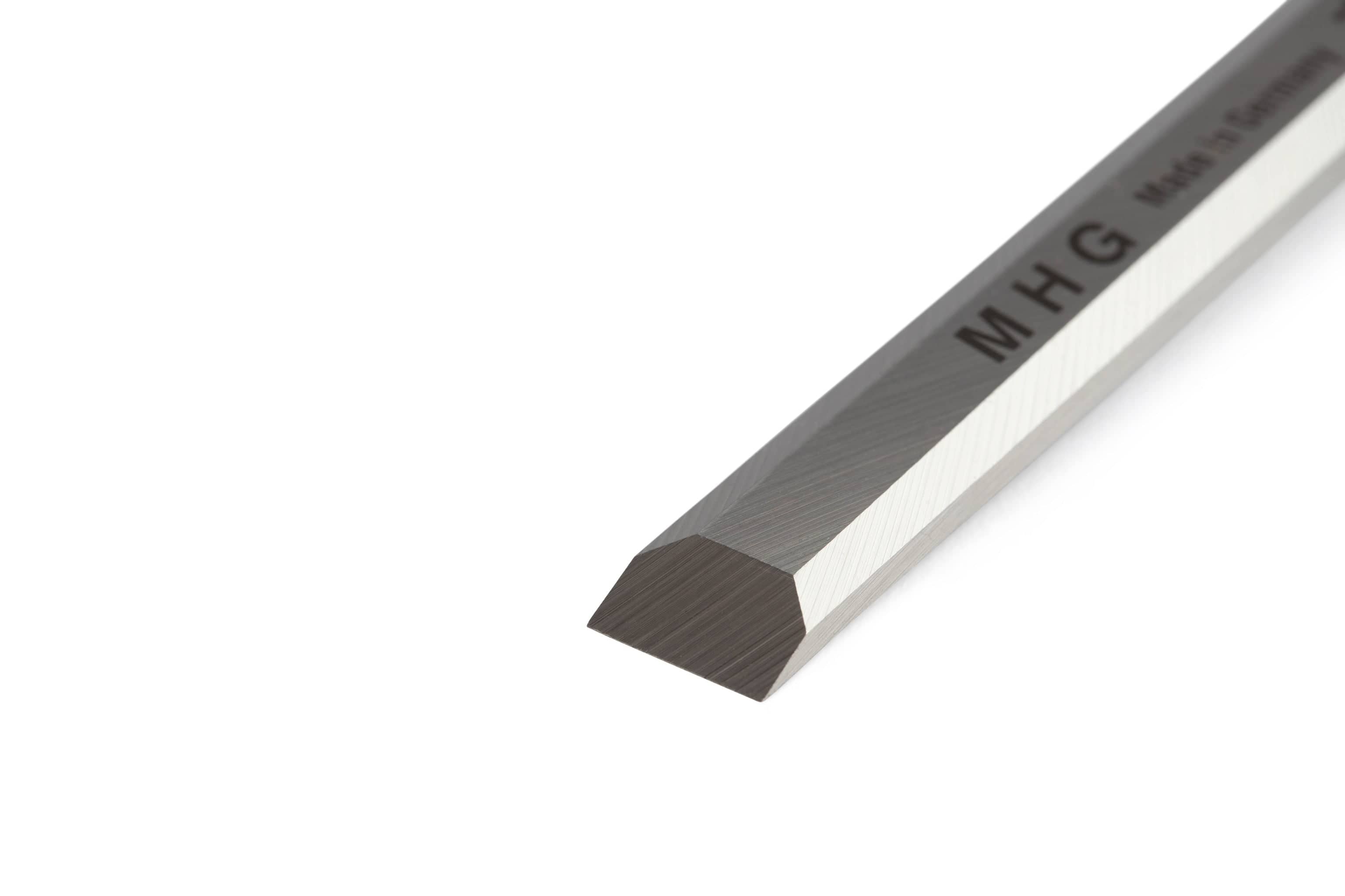 A close-up of the MHG Firmer Bench Chisel, a hexagonal metal bar with beveled edges, displays the MHG logo and Made in Germany partially visible on its surface.