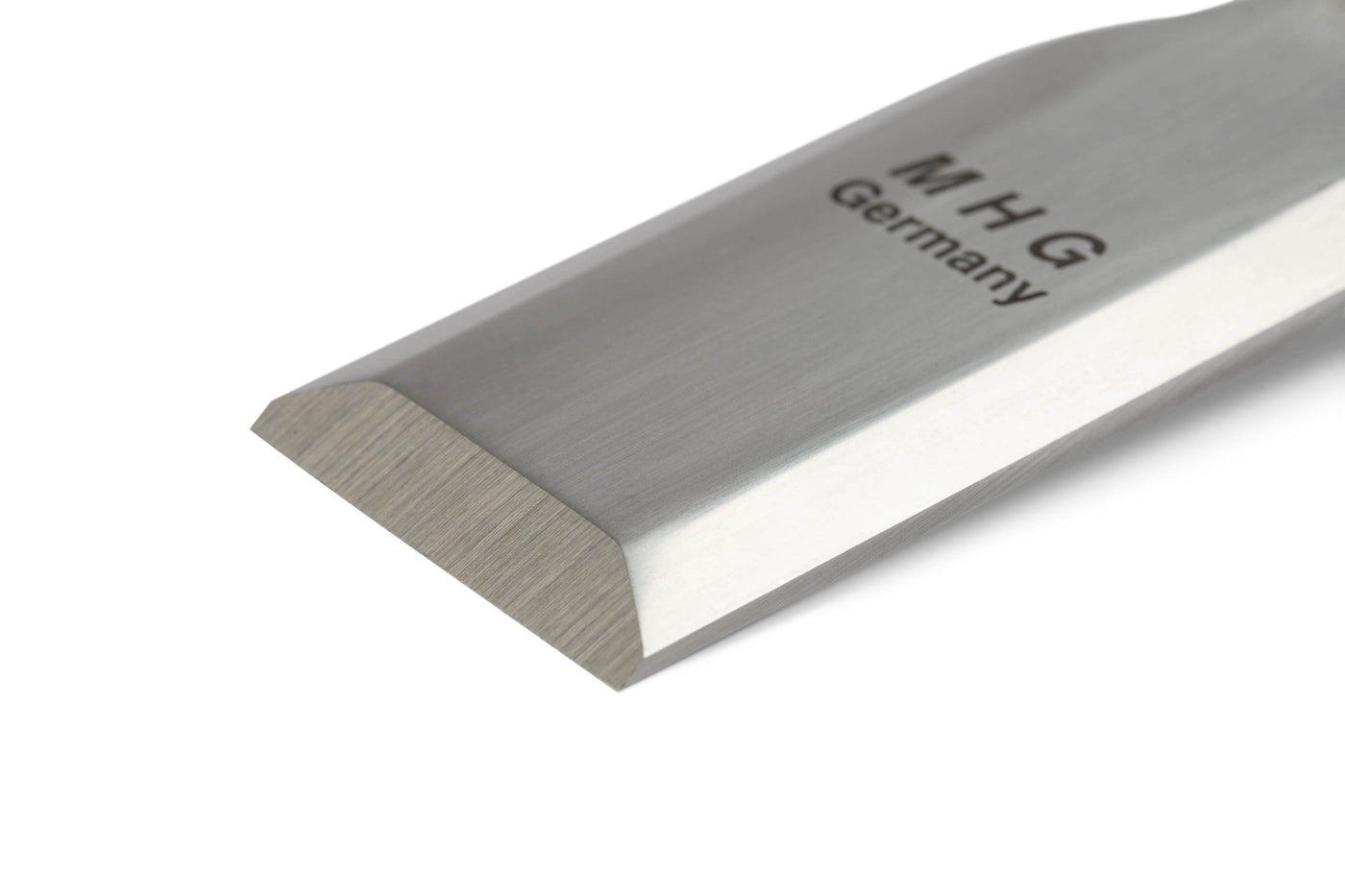 Close-up of the MHG Butt Chisel’s precision beveled blade, engraved with MHG near the handle. Its sharp, clean finish makes this MHG woodworking tool perfect for detailed work.