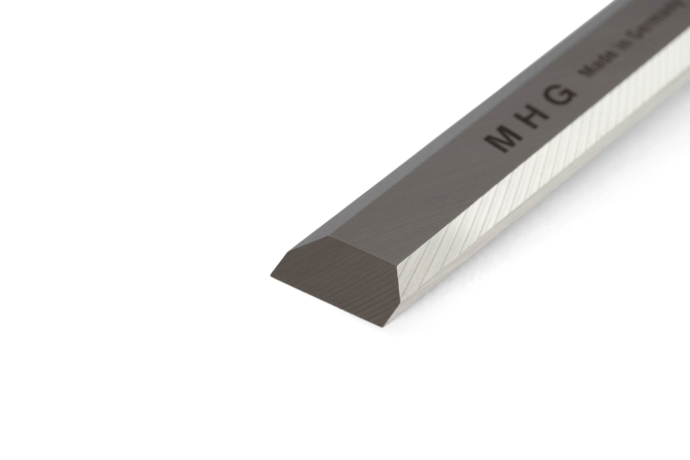 A close-up of the MHG Firmer Bench Chisel, a metal bevel edge tool from MHG used in fine woodworking, photographed against a white background.