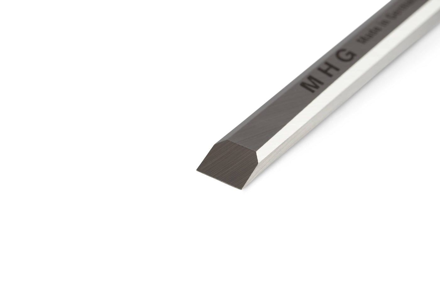 A close-up of the MHG Firmer Bench Chisel, a precision-crafted woodworking tool with a beveled edge and MHG branding on the shaft, set against a white background.
