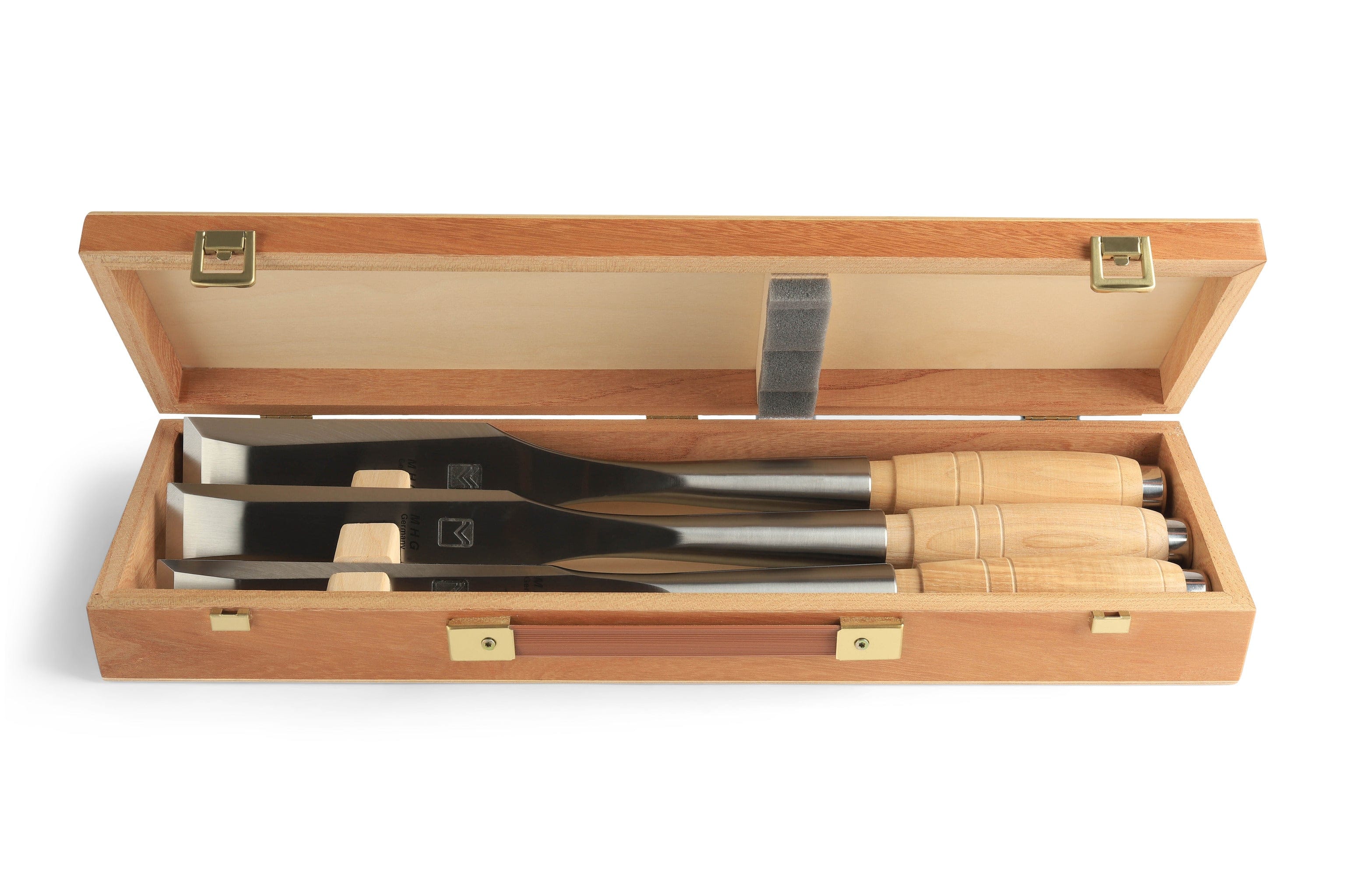 An MHG Messerschmidt Timber Framing Chisel set featuring three professional tools with wooden handles, securely arranged in a compartmentalized wooden box.