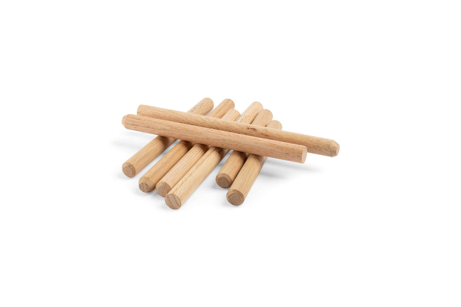 A stack of Northcott Wood Turnings Timber Frame Oak Pegs, 3/4-in in diameter, is arranged in a crisscross pattern against a white background.
