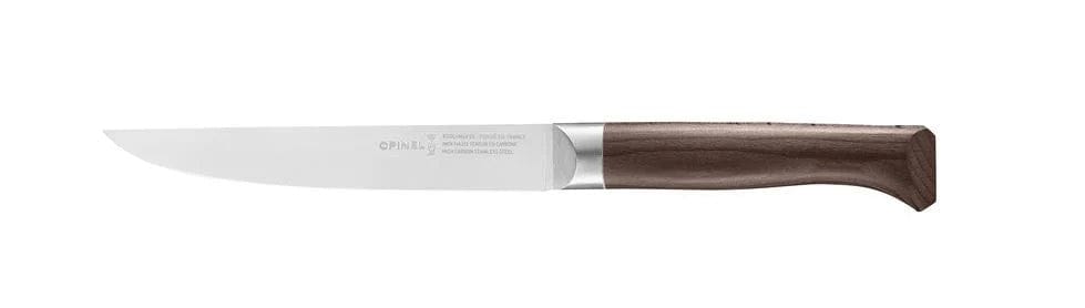 The Opinel Le Forges 1890 Kitchen Knife features a long, slender blade made from X50CrMoV15 steel and a wooden handle, showcasing the elegance of French cutlery.