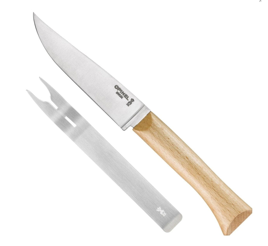 The Opinel Cheese Knife and Fork Set features a stainless steel knife with a beech wood handle and a narrow two-pronged fork, both displayed on a white background.