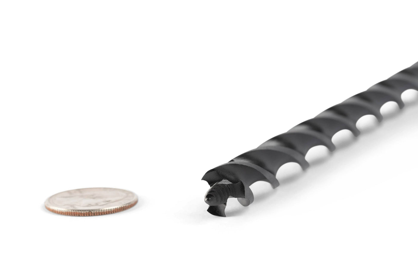 A close-up of a black OWL Wood Owl Ultra Smooth Tri-Cut Auger Bit 18-in beside a U.S. quarter on a white background, showcasing its size, efficient chip ejection, and advanced design.