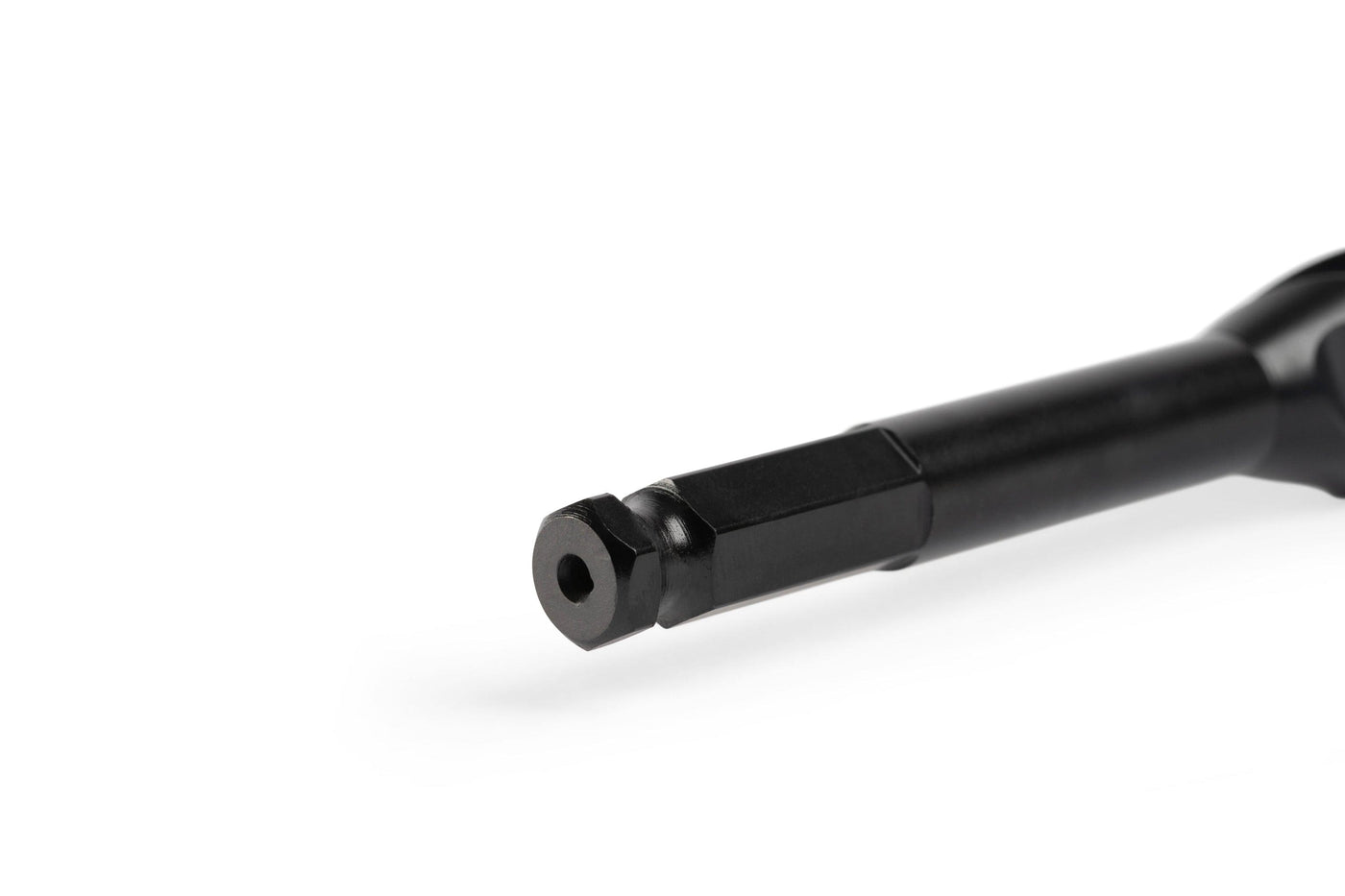 Close-up of a black Wood Owl Ultra Smooth Tri-Cut Auger Bit 18-in by OWL, made from high-carbon S55C steel with precision-ground flutes and a hexagonal shank, isolated on white.