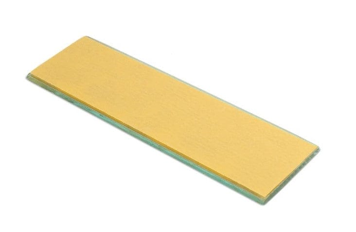 The Shelter Institute Shelter Sharpening Kit includes a rectangular glass microscope slide with a gold-colored coating—perfect for precise inspection during honing guide or woodworking sharpening tasks.