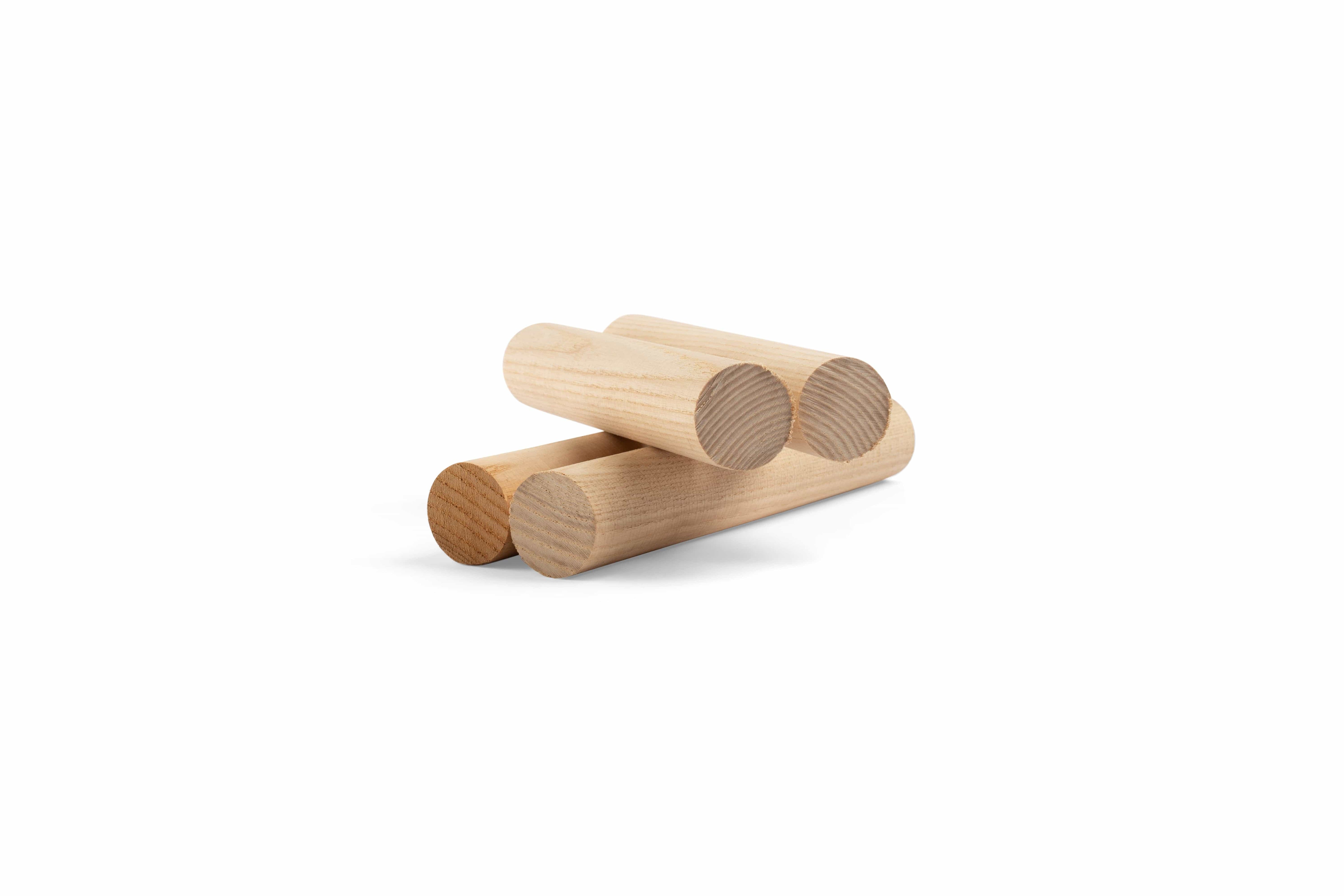Three Timber Frame Oak Pegs by Shelter Institute, each with a 1-1/4-in diameter, are stacked on a white background, capturing the essence of traditional joinery.