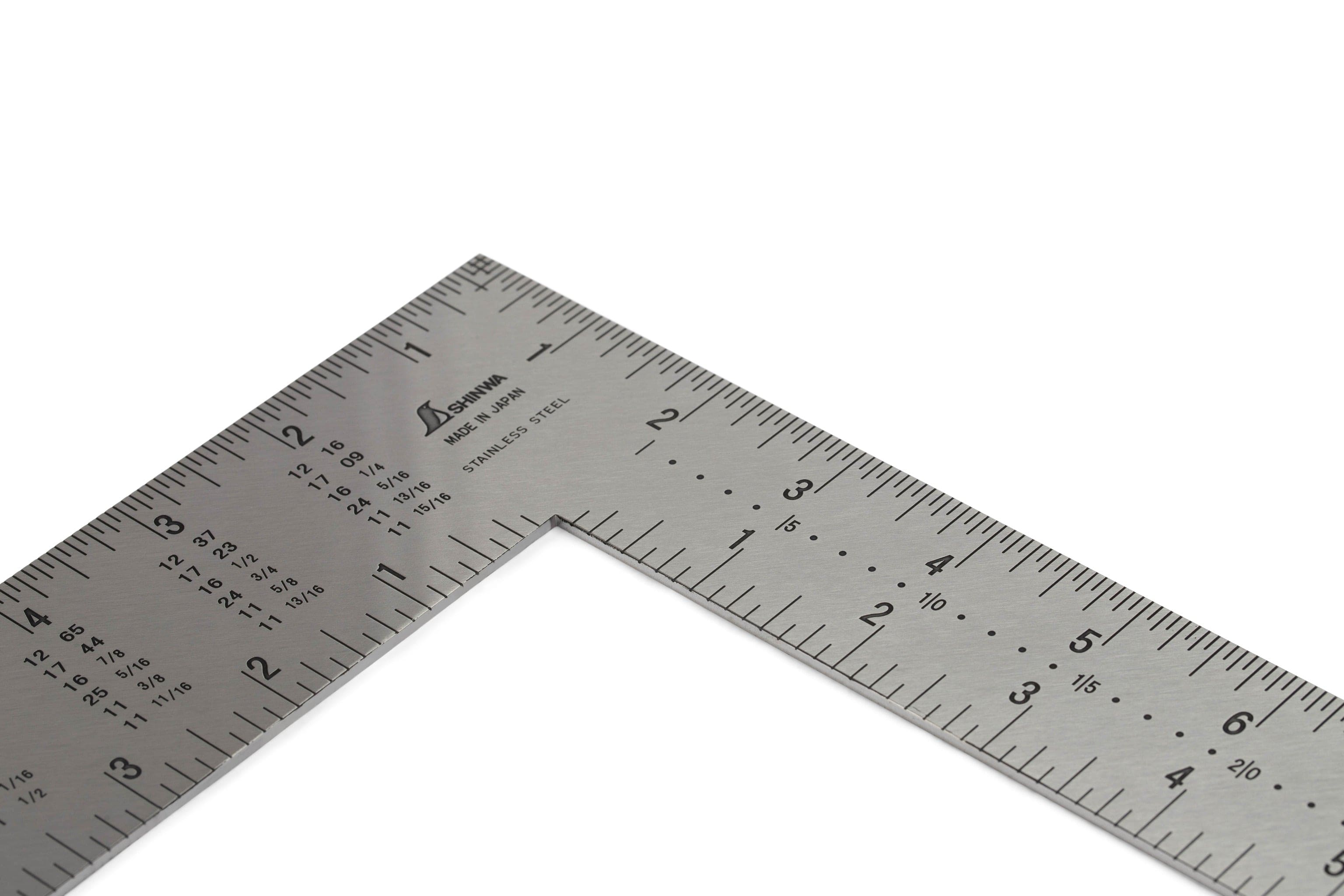 The SHWA Shinwa Japanese Framing Square is a stainless steel carpenter’s tool with inch and centimeter markings on both arms, featuring a clear white background.