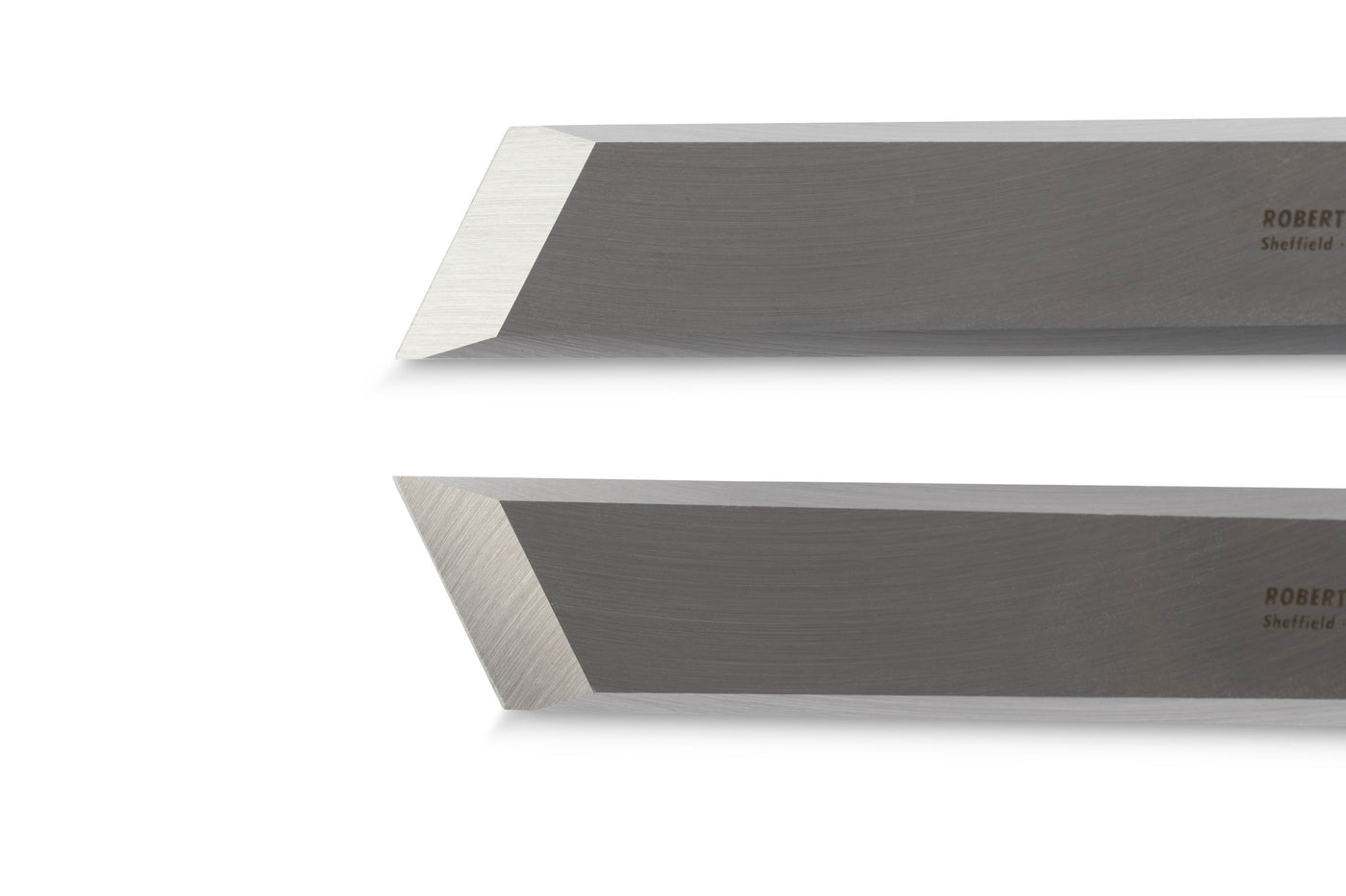 Close-up of two SOR skew chisels with angled blades, highlighting their sharp, shiny edges. The Robert Sorby Skew Chisel Set is perfect for precision joinery and delivers exceptional craftsmanship.