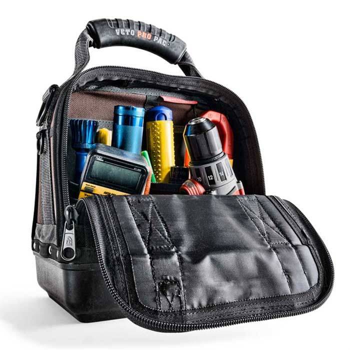 A VET CLOSED TOP TOOL BAG-MC shows its neatly organized tools—multimeter, pliers, screwdrivers, drill, and wire strippers—each arranged in separate pockets.