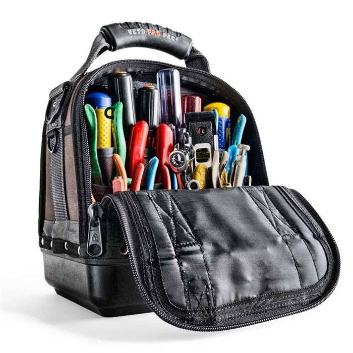A VET CLOSED TOP TOOL BAG-MC in black with its front unzipped, shows screwdrivers, pliers, cutters, and measuring tape neatly arranged in upright pockets—perfect for professionals needing a reliable technician bag.