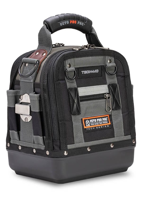 The VET TOOL BAG TECH MC is a black and gray technician tool bag with a hard plastic base, multiple external pockets, padded handle, and VET logo patch on the front.