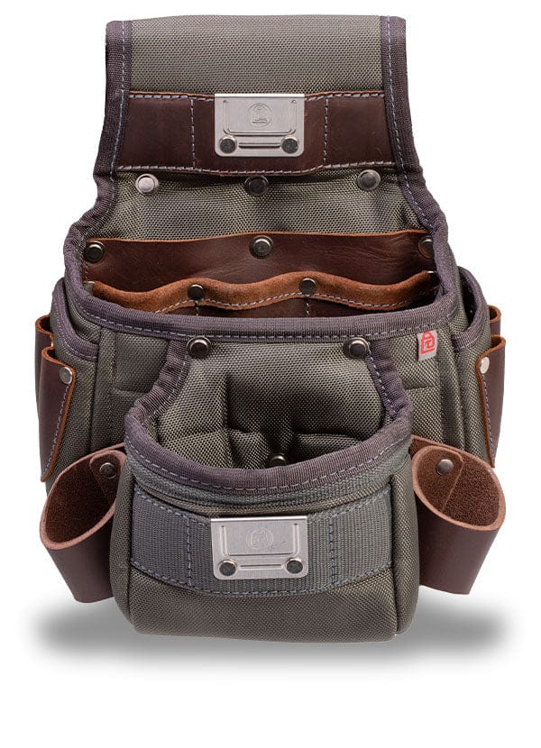 The VET Builder's Belt is a gray and brown canvas tool pouch with leather accents and metal rivets, featuring multiple pockets and compartments. It easily attaches to an adjustable tool belt for convenient carrying of tools and accessories.