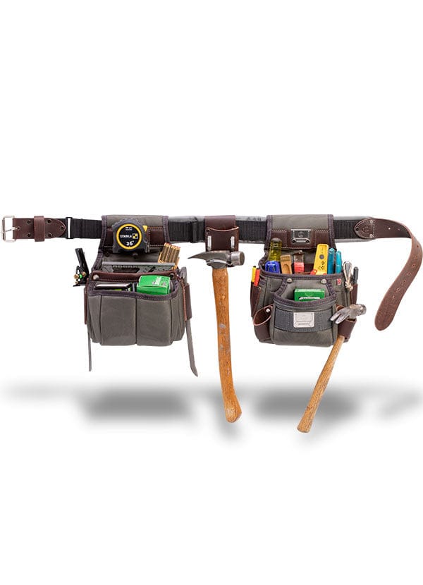 The VET Builder's Belt is an adjustable brown leather tool belt with multiple pouches for carrying tools like a tape measure, pencils, hammer, screwdriver, utility knife, and pliers—offering comfort and convenience for any project.